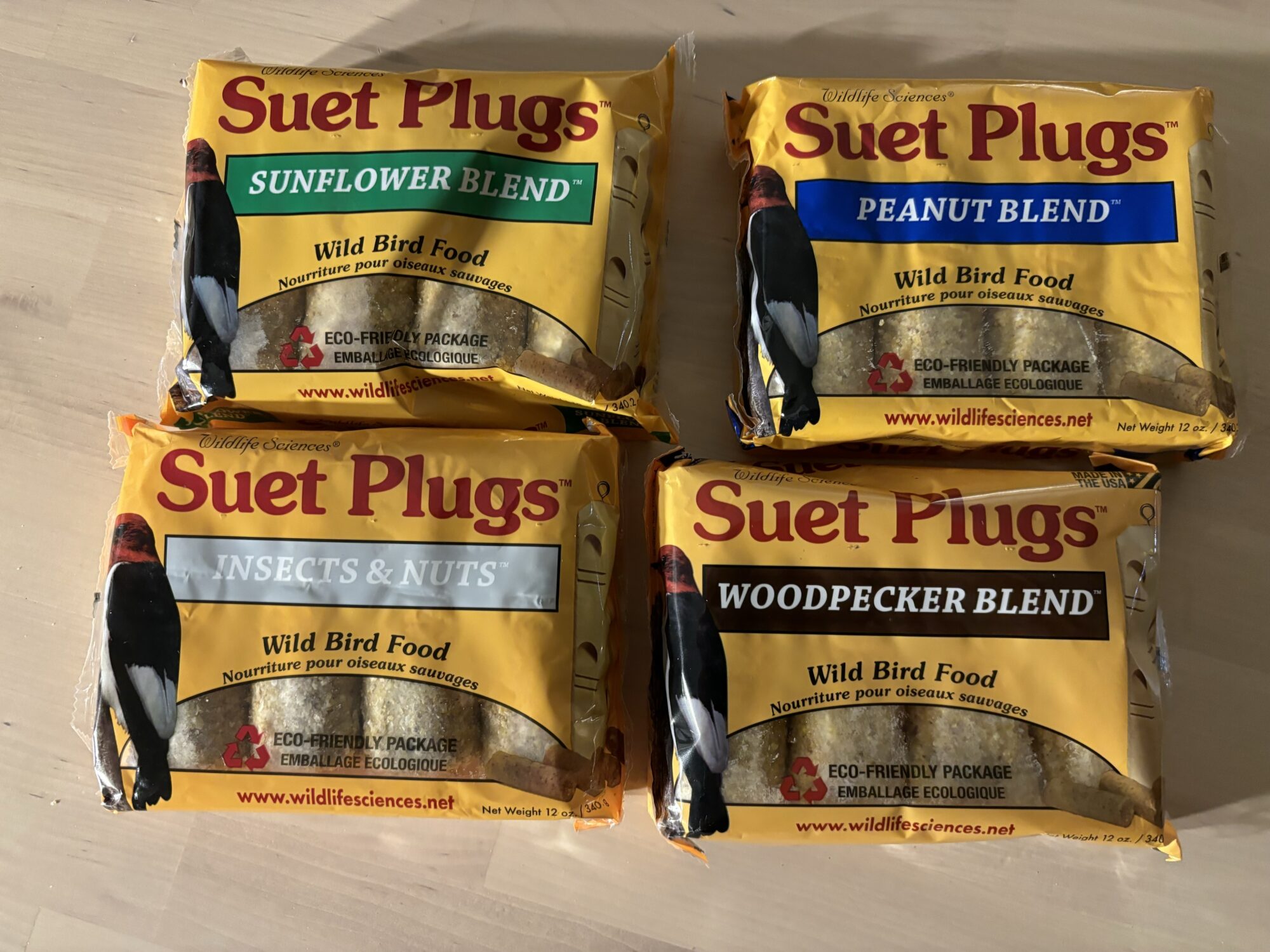 A variety pack of suet plugs for bird feeding on a table.