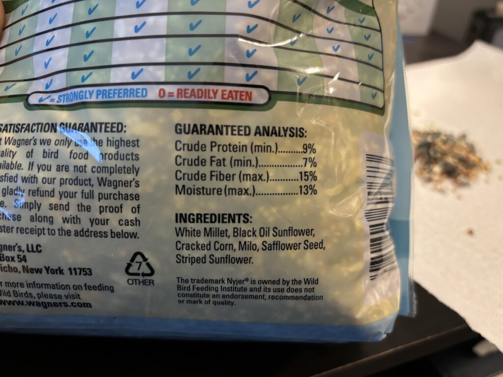 The back of a bag of bird seed showing the ingredients. 