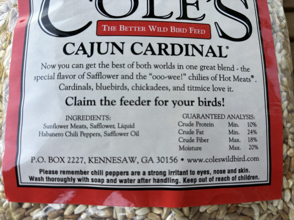 A close up view of the ingredients in a bag of Cole's Cajun Cardinal bird seed. 