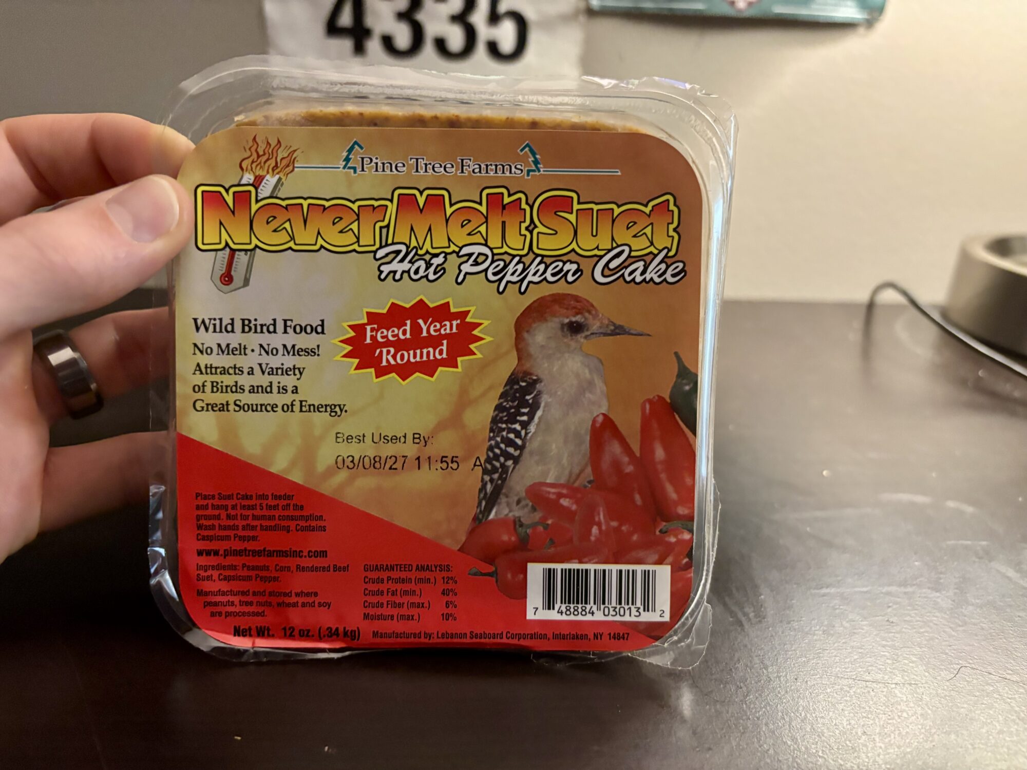 A picture of spicy hot pepper suet sitting on a desk.